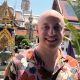 Santiago Saca smiling outdoors at the Grand Palace in Bangkok